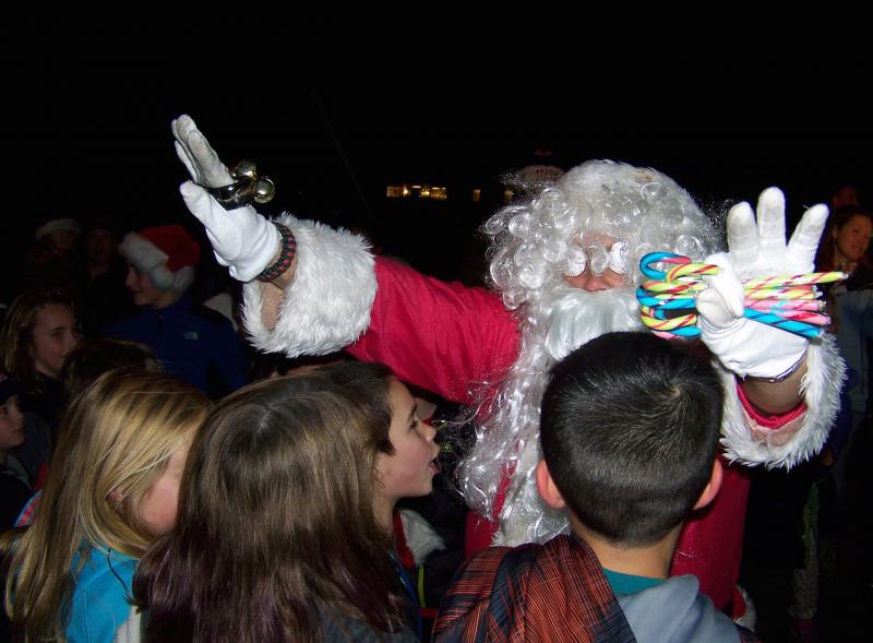 Santa requests some personal space from the hungry hordes of children at Rochester's tree lighting on Monday. BY MATTHEW BERNAT